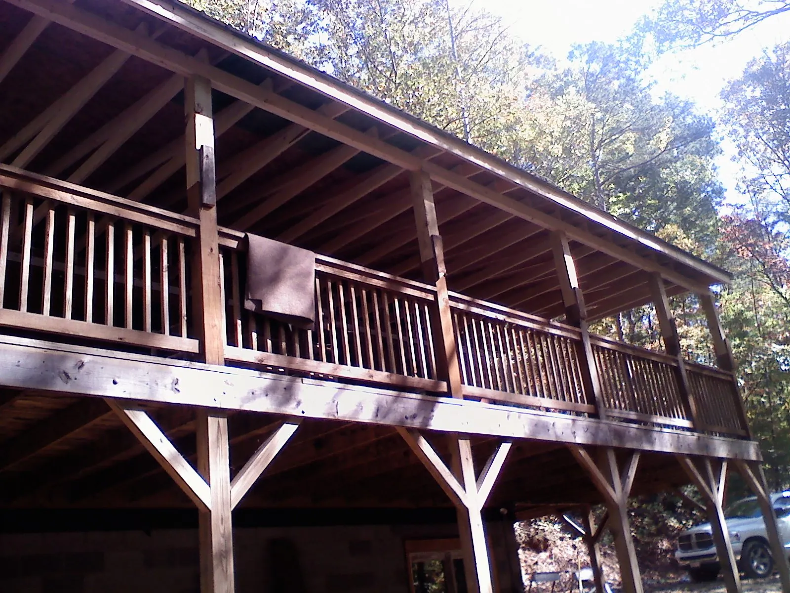 Timber framing under a new elevated porch and deck in Artemas