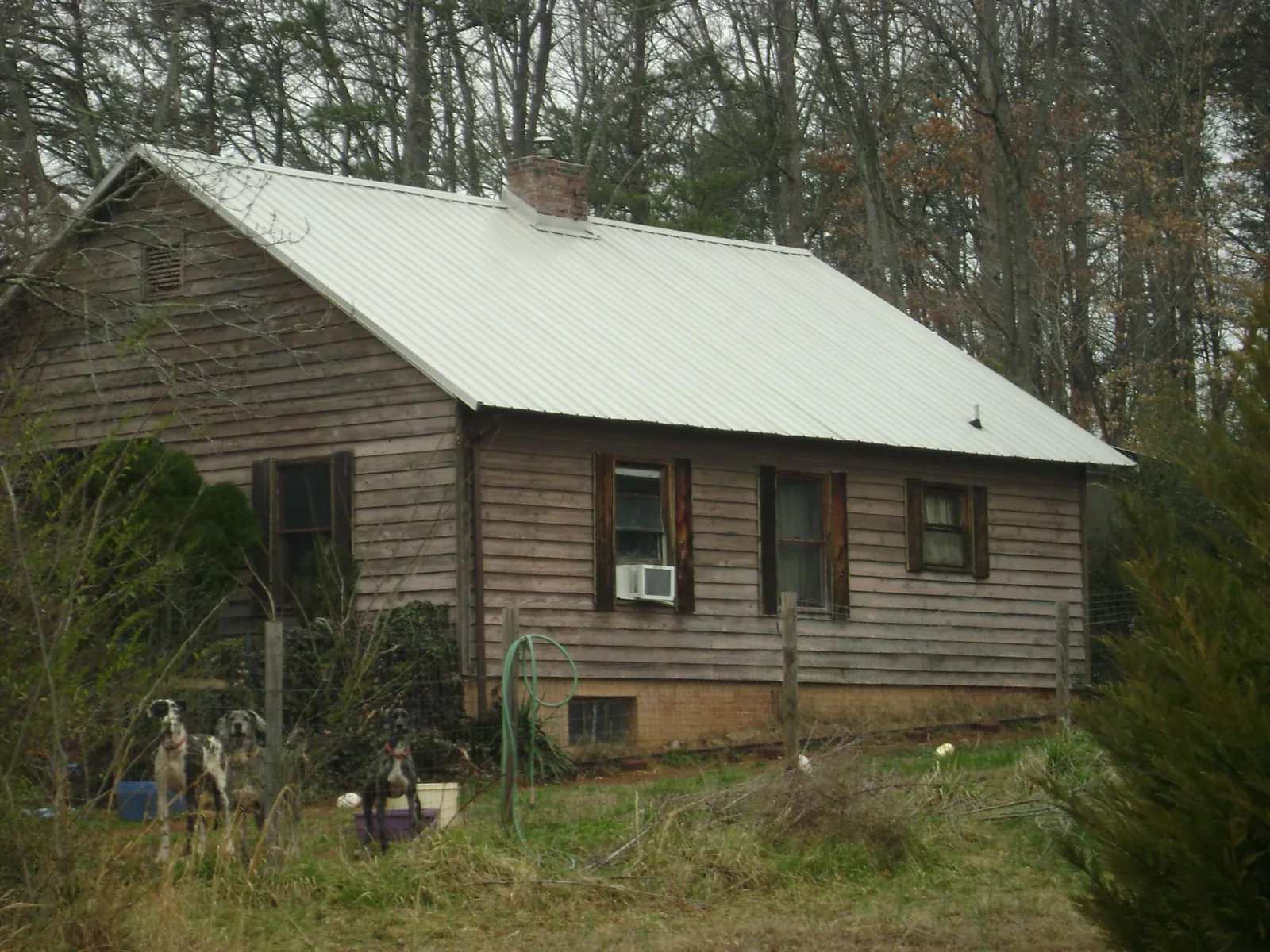 White metal roof on an old wood sided farmhouse, from a Metal Roof Installation job in Artemas